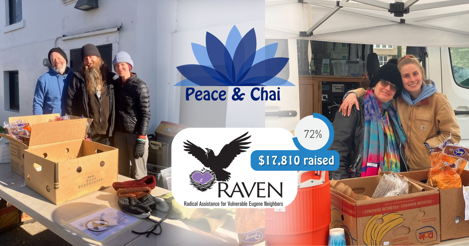 volunteers smiling together in front of a table of food and other resources.